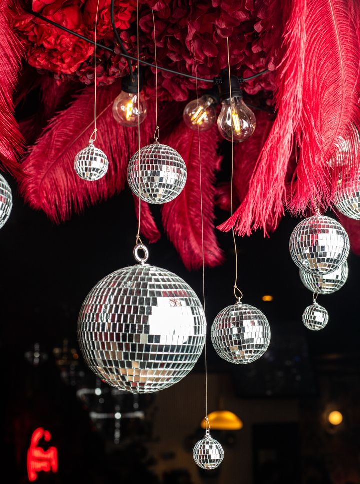 Red feather and mirror ball installation at Curry Mee
